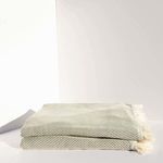 Jordan Bath Towel folded, olive color with subtle diagonal stripes and fringed edges