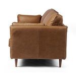 Profile view highlighting clean back seam and almond tapered legs