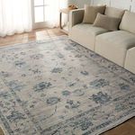 Rug styled in living room with beige sectional couch and natural light from window