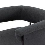 Close-up showing textured boucle fabric wrapping the yoke back and seat cushion