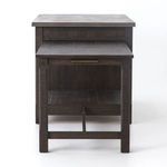 Close-up of corner showing joinery between concrete top and wooden frame with pull-out table