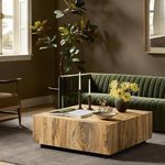 Hudson Square Coffee Table styled in living room setting with green velvet sofa and decor