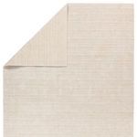 Top corner folded to reveal double-sided striped pattern in cream tones