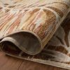 Curled corner revealing rug’s backside weave and soft pile height on hardwood floor