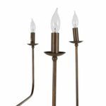 Close-up of three candle-style bulbs showing brushed copper candle holders and flame-shaped clear bulbs