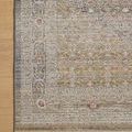 Partial top-down view focusing on detailed border pattern and soft color transitions on light wood floor
