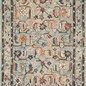 Transitional wool rug with whimsical floral motifs in muted blue, orange, and cream, featuring braided tassels on ends