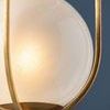 Verbank pendant light with vintage gold leaf cage encasing a softly glowing cloud glass orb