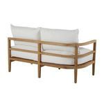 Back angled view showing natural finish teak frame supporting white cushions