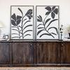 Two similar botanical paintings styled side by side on a long wooden console