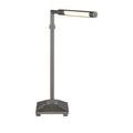 Lamp lit from front with arm and shade in horizontal position, base clearly visible