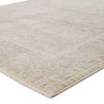 Close-up corner view showing subtle distressed detailing and low pile texture of rug