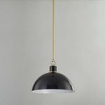 Glossy black pendant light hanging against light gray wall with pendant switched off