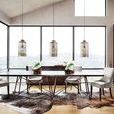 Dining room view with sideboard in background underneath large windows and pendant lights