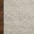 Rug laid on dark hardwood floor highlighting corner and woven texture in natural light