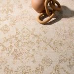 Macro detail of rug surface showing fine woven fibers beneath a terracotta ceramic pendant accessory