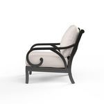 Side profile of Monterey Club Chair showing curled arm design and beige cushions
