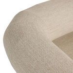 Close-up on curved seat corner showing fabric weave and cushioning thickness