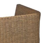 Angled side view showing wrapped rattan frame and tufted cushion of bench