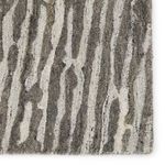 Detailed view of dense pile showing dimensional striped pattern in gray and ivory hues