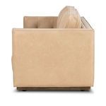 Side profile showing smooth nude leather armrest and base detail