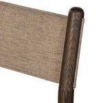 Close-up angle of Morena chair seat's beige fabric upholstery and wood frame