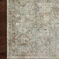 Detailed corner view highlighting rug’s texture, weave, and soft muted color pattern on wood flooring