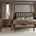 Bedroom setup with Clarendon canopy bed, nightstands, dresser, and flowering branches on left