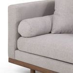 Close-up of left arm with bolster pillow and seam detail on silver fabric upholstery