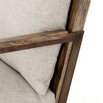 Detailed close-up of armrest corner showing wood texture and metal frame intersection
