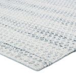 Close-up corner view showing woven texture and detailed gray and cream yarn pattern