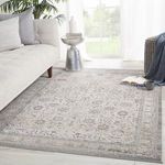 Rug positioned in a modern room setting with natural light, neutral sofa, and decorative pillows