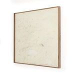 Angled side view showing depth and natural wood grain of the frame around painting