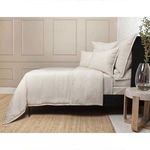 Natural-colored Georgie Bamboo Linen Duvet set on bed with matching pillow shams in a styled bedroom