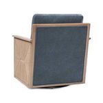 Back view with solid blue upholstery on the chair’s back panel framed by light wood