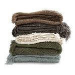 Stack of Murphy oversized throws in brown, charcoal, cream, olive, and blue colors showing color variations