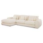 Angled perspective of Berga sectional showing left chaise and plush cushions on cream fabric