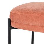 Close-up showing texture of rust-colored fabric seat and black metal frame detail