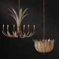 Foliatura chandelier lit and suspended alone on a dark textured wall background