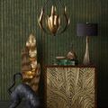 Endymion Chandelier hanging in a styled room with green textured wall and decorative gold and black accents