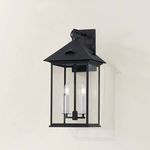 Close-up side view of Corning Exterior Wall Sconce highlighting clear glass and candle-style bulbs