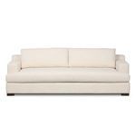 Living room setting with Crispin Sofa, featuring neutral walls, wooden floors, modern lighting, and simple decor