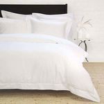 White Classico Hemstitch Cotton Sateen Euro Sham on a bed with hemstitch border and smooth sateen finish
