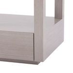 Close-up of side panel showing straight-grain oak texture and drawer edge