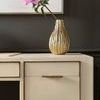 Close-up of drawer front on Hunter Desk with textured gold vase and pink flower decoration