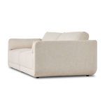 Angled rear view of Toland sectional focusing on upholstery and cushion alignment