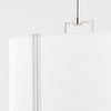 Close-up showing texture of white Belgian linen diffuser and polished metal bands on pendant