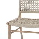 Close-up of seat weaving texture with ivory rope on teak frame