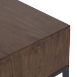 Close view of leather pull handle attached to drawer front with metal fastener