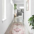 Skye Ivory / Berry Rug as narrow runner in a bright hallway with plants and minimal decor